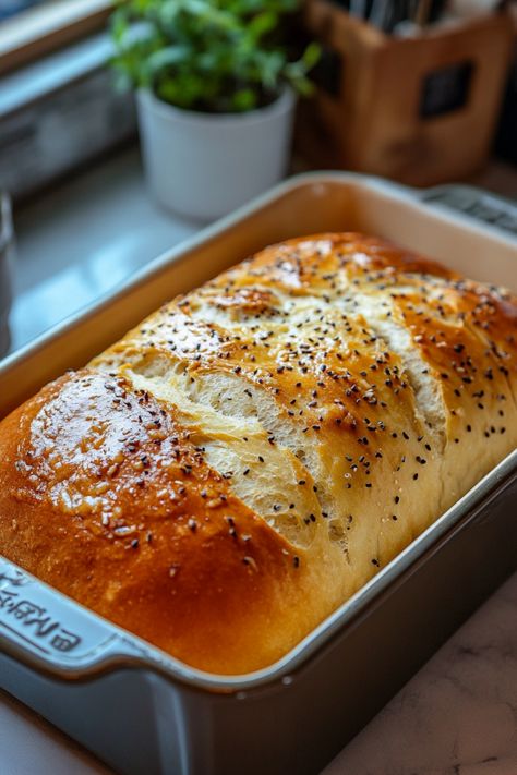 Freshly baked loaf of bread in a baking pan, topped with sesame seeds and crispy golden crust. Homemade Bread Machine Recipes Easy, How To Make Bread In Bread Machine, 3 Pound Bread Machine Recipes, Bread Machine Bread Dough, Sweet Bread Maker Recipes Easy, Mediterranean Bread Machine Recipes, Homemade Bread Bread Machine, Special Bread Recipes, Sugar Free Bread Machine Recipes