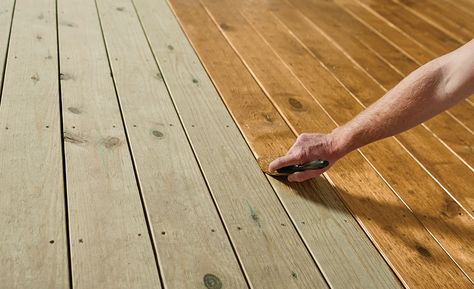 A person waterproofing a deck with a tinted exterior wood sealer. Staining Treated Wood, Deck Plans Diy, Porch And Patio Paint, Deck Sealant, Outdoor Wood Decking, Deck Stain And Sealer, Outdoor Wood Stain, Wood Deck Stain, Treated Wood Deck