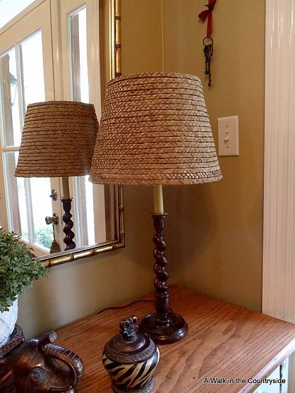 We love this DIY Ballard Seagrass inspired lamp made by awalkinthecountryside.com.  Her DIY version includes a wooden lamp, lamp shade, rattan placemat and glue. Unravel placemat and glue onto shade in layers.  Looks like seagrass but for a whole lot less! Cat Lamp, Diy Outdoor Lighting, Diy Lamp Shade, Cool Lamps, Outdoor Light Fixtures, Wooden Lamp, Diy Lamp, Ballard Designs, Vintage Lamps