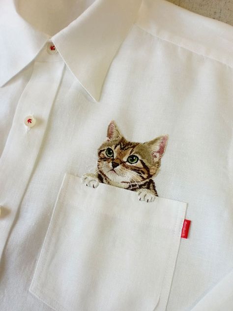 Embroidered Cat Shirts By Hiroko Kubota Go Viral And Sell Like Hot Cakes | Bored Panda Detail Couture, Pocket Cat, Pola Sulam, Cat Fashion, Japanese Embroidery, 자수 디자인, A Button, 가을 패션, Embroidery Inspiration