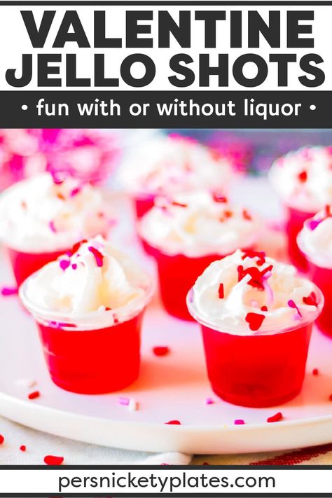 Celebrate Valentine's Day with your loved ones this year with these delicious Valentine's day jello shots! Made with layers of pink and red jello infused with clear vodka (or left non-alcoholic), they couldn't be easier to make. Topped with whipped cream and sprinkles, these irresistible jello shots are always a hit! | www.persnicketyplates.com Valentine Jello, Jello Shooters, Persnickety Plates, Jello Shots Vodka, Cranberry Jello, Jello Flavors, Fuzzy Navel, Fun Valentines Day Ideas, Kid Friendly Drinks