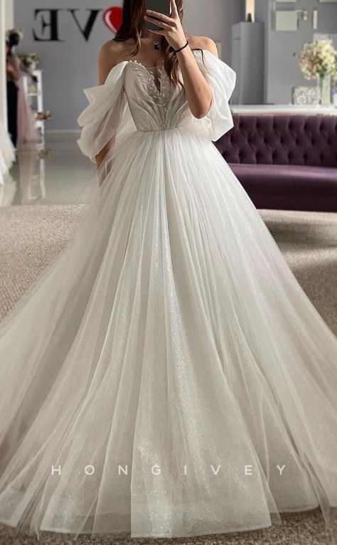 Expertly crafted for the most special day, this A-Line Off-Shoulder Wedding Dress exudes elegance. The delicate appliques add a touch of glamour and the glittery sheer tulle creates a captivating look. Say "I do" in style and make a lasting impression on your big day. Off Shoulder Tulle, Wedding Dress With Feathers, Off Shoulder Wedding Dress, Beach Wedding Dress Boho, Bridal Dresses Lace, Mother Wedding Dress, Princess Ball Gowns, Applique Wedding Dress, Tulle Wedding