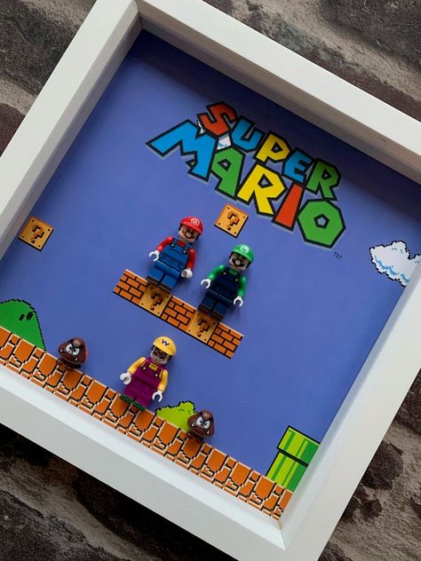 Super Mario Brothers - Mario, Luigi and Wario MiniFigz Framed, Nintendo gift idea, ideal gift idea for Nintendo game lovers everywhere!  High quality frame available in 3 colours; White, Grey & Black.  External Frame: 25 x 25cm Depth: 3cm (1.2 inches) Includes wall hanging for mounting. Super Mario Bros Gifts, Mario Bedroom, Hot Wheels Diy, Mario Luigi, Computer Game, Super Mario Brothers, Nintendo Game, Mario Brothers, Game Lovers