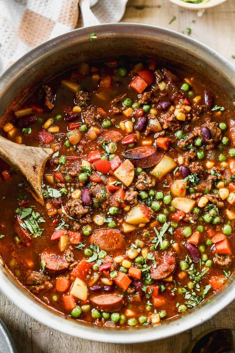 With ground beef, kielbasa, beans, potatoes and veggies, this hearty cowboy stew recipe has chili vibes but packs in even more satisfaction! Camping Stew Recipe, Kielbasa Beans, Camp Stew Recipe, Cowboy Soup Recipe, Beef Kielbasa, Cowboy Stew Recipe, Meat Soups, Cowboy Cooking, Cowboy Stew