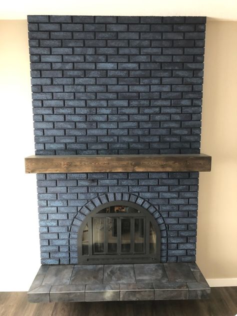 Painted fireplace first with SW primer, then 2 coats of Naval. Last was a wash (1 part white, 1 part blue, 4 parts water) painted and dabbed one to three bricks at a time. Mantle was built out of knotty pine. Distressed and stained with Varathane Kona. Installed using a french cleat attached to old mantle. Brass doors were scuff sanded and spray painted with Rust-Oleum high heat enamel. Lastly, the tiles were removed from the hearth and replaced with Gulfstream Islands tile. Blue Brick Fireplace Paint Colors, Charcoal Blue Fireplace, Dark Blue Painted Brick Fireplace, Dark Blue Brick Fireplace, Painted Brick Fireplace Color, Navy Blue Painted Brick Fireplace, Navy Blue Brick Fireplace, Navy Painted Fireplace, Blue Painted Brick Fireplace