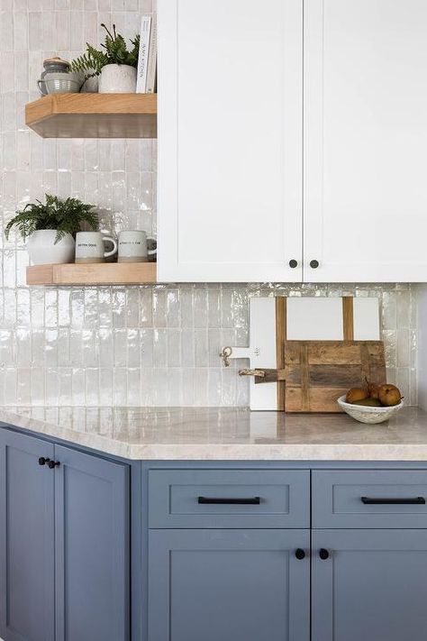 White and blue kitchen features gray glazed vertical stacked wall tiles with white upper cabinets and blue lower cabinets that boast black pulls. Salt Interiors, White Upper Cabinets, Pure Salt Interiors, Light Blue Kitchens, Lower Cabinets, Pretty Homes, Turtle Rock, Beach Dining, Pure Salt