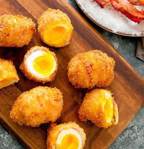 Soft boiled eggs are wrapped in bacon and coated in panko bread crumbs before being deep fried until golden brown. The eggs have a crunchy shell, a smoky bacon wrap and a soft-yolk center. It’s a delicious appetizer that is sure to impress your guests and perfect for game day. Super Bowl Sunday is almost here! My mind … Deep Fried Soft Boiled Eggs, Deep Fried Boiled Eggs, Egg Appetizers, Deep Fried Bacon, Village Tavern, Deep Fried Egg, Fried Bacon, Fried Breakfast, Fair Food