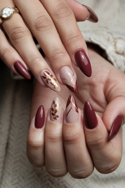 Embrace the beauty of autumn with these chic acrylic fall nail ideas that perfectly capture the season's essence. Picture deep burgundy and burnt orange swirls adorned with delicate gold leaf accents, showcasing a warm, inviting vibe. These nails not only add a touch of sophistication but also express your appreciation for fall窶冱 rich colors. Get inspired and bring the essence of autumn to your fingertips! November Birthday Nails Ideas, Burgundy And Gold Almond Nails, Fall Nails Pink And Brown, Maroon Autumn Nails, Wine And Gold Nails Designs, Burgundy Thanksgiving Nails, Burgundy With Gold Nails, Fall Nails Burgundy Gold, Autumn Wedding Nails For Bride