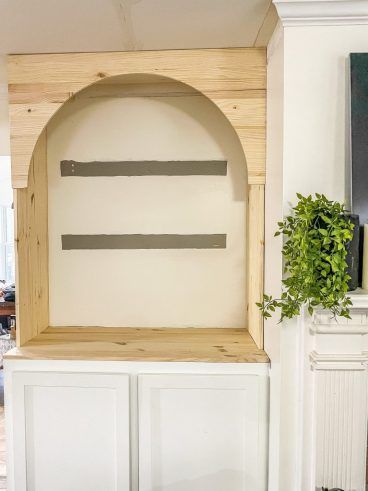 Built In Cabinet With Arch, Arch Storage Wall, Faux Arched Door, Archway Built Ins, Diy Arch Shelves, Built In Arch In Wall, Painted Arch With Floating Shelves, Arched Cabinets By Fireplace, Diy Arch Built In Shelves