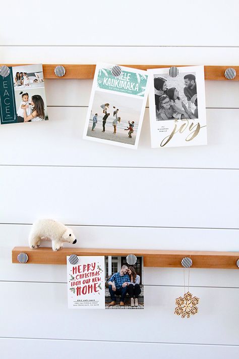 DIY Holiday Card Display: Magnetic Picture Rails | Minted. | Bloglovin’ Holiday Card Display, Picture Rails, Paint Stirrers, Greeting Card Display, Christmas Card Display, Diy Holiday Cards, Unique Christmas Cards, Picture Rail, Picture Hook