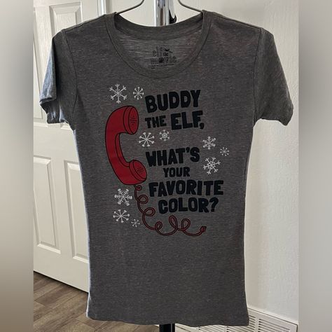 This Shirt Is Brand New With Tags. It’s A Gray Short Sleeve Top That Has A Telephone Graphic And The Words, Buddy The Elf, What’s Your Favorite Color? Elf Movie Shirts, Elf The Movie, Tardis Blue, Elf Movie, Black Short Sleeve Shirt, Buddy The Elf, The Office Shirts, Gray Top, Purple T Shirts