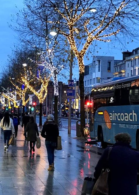 Illuminated trees on a city street with a bus parked beside a sidewalk Dublin Christmas Aesthetic, Dublin Winter Aesthetic, Winter In Ireland, Dublin Winter, Christmas Ireland, Dublin Christmas, Ireland Winter, Ireland Christmas, Dublin Map