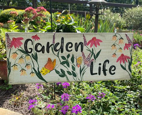 Garden Life at its best!  Hang this beautiful unique hand painted sign anywhere in your yard, on your patio, deck, etc. and it will brighten up the surroundings year round.  It represents everything we love about being in the garden.  Perfect gift for any occasion.  Every sign is painted as I go, inspired by my life in the garden.  No two signs will be exactly the same, and you can request any personalization you would like.  This sign uses a silver wire to hang by, but you can request sawtooth hardware, or a chain.  I want you to be thrilled about your one of a kind treasure. Hand Painted Garden Signs, Garden Signs And Sayings, Garden Signs Diy, Outdoor Wood Signs, Paw Painting, Garden Fence Art, For Mom, Eco Garden, Custom Yard Signs