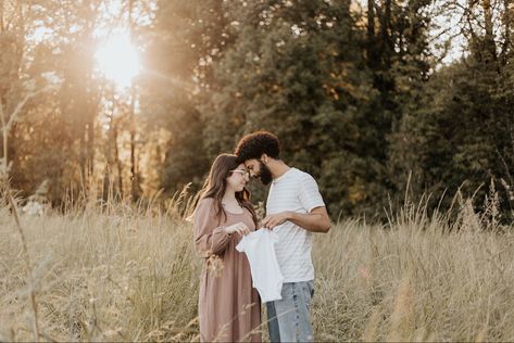 Man and woman forehead to forehead smiling holding up a white baby onesie in front of them Onsie Maternity Picture, Onsie Announcement Pregnancy, Pregnancy Announcement With Onesie, Onsie Announcement, Sonogram Pregnancy Announcement, Family Baby Announcement, Pregnancy Announcement Pictures, Announcement Pictures, Announcement Photoshoot