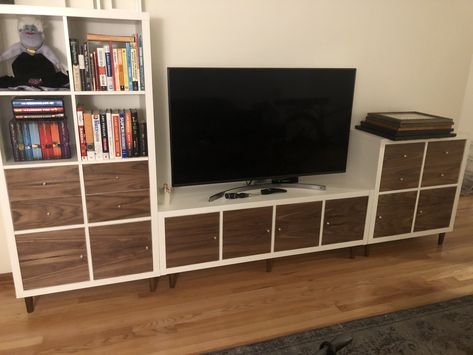 This is three Ikea Kallax units. I added legs from Prettypegs.com and covered the door and drawer front with walnut veneer I bought off Amazon.com. I also drilled a 2” hole for cable management so all the cables are well hidden. Ikea Kallax Tv Unit, Ikea Kallax Hack Tv Stands, Kallax Entertainment Center, Ikea Kallax Tv Stand, Kallax Tv Unit, Ikea Cube, Tv Hidden, Diy Kallax, Kallax Unit