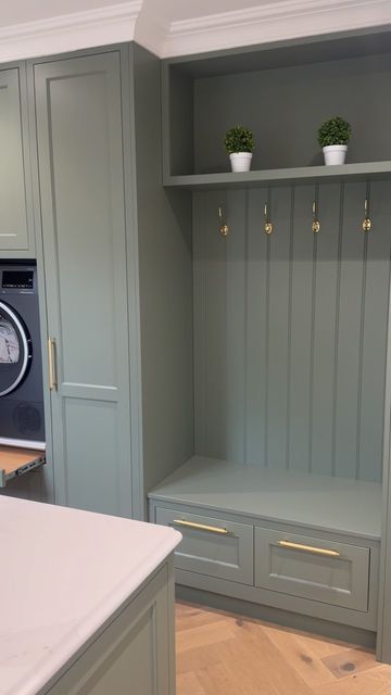 Trevor McDonnell Kitchens on Instagram: "The utility room at the “ Brookhill house project “  . . . We love the boot bench and the raised washer & dryer in this utility room. it made life for our clients so functional  . . A green utility room with raised washing machine and dryer combines practicality with a fresh, vibrant aesthetic. The green color palette, ranging from soft sage to rich emerald, infuses the space with a sense of calm and connection to nature.  The washing machine and dryer are elevated on sturdy platforms, making them easily accessible without the need to bend down, which enhances ergonomic convenience. These platforms often include built-in storage drawers underneath, perfect for housing laundry detergents, fabric softeners, and other cleaning supplies.  Cabinetry in c Cleaning Supply Storage Laundry Room, Raised Washing Machine, Sage Laundry Room, Raised Washer Dryer, Green Utility Room, Utility Room Inspiration, Boot Bench, Utility Space, Entrance Hall Decor