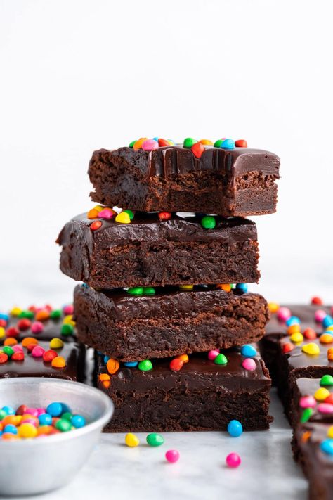 Rich and fudgy take on a whole new meaning with this homemade cosmic brownies recipe! These sweet treats begin with a chewy brownie base that's topped with silky chocolate ganache and rainbow chip sprinkles. Cosmic Brownie Recipe, Cosmic Brownies Recipe, Homemade Cosmic Brownies, Cosmic Brownies, Chewy Brownies, Brownies Recipe, Brownie Bar, Brownie Recipes, Chocolate Ganache