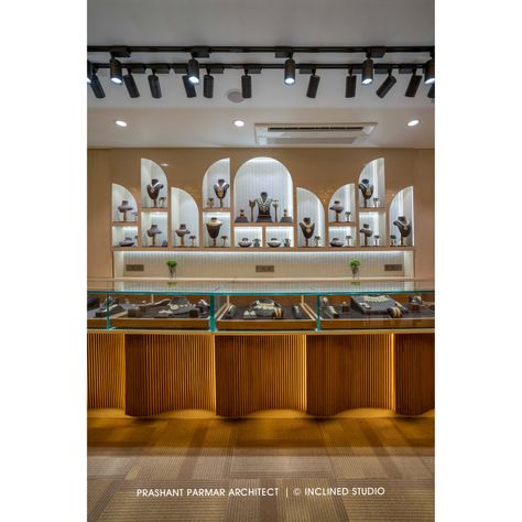 For providing the Spacious Feeling to the Space, the backdrop is designed with the combinations of arched mirrors. The curved arches for showcasing the jewellery and soft, irregular shape of the curved fluted panels below the counter adds luxurious look to the showroom.
.
“A Jewellery Boutique Design”
Location: C G Road, Ahmedabad, Gujarat, India.
Carpet Area: 1,500 Sq. Ft.

PC:  Inclined Studio Jewellery Display Counter Design, Jewelry Interior Design Shop, Showroom Counter Design, Jewellery Counter Design, Jewellery Shop Counter, Display Counter Design, Jewellery Showroom Interior Design, Jewelry Store Interior Design, Prashant Parmar