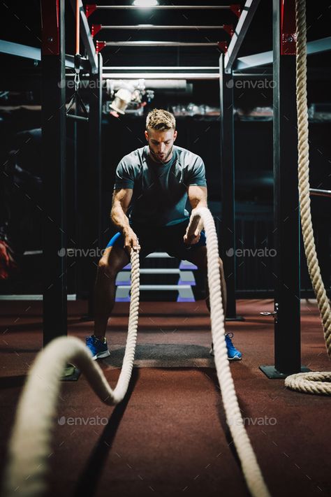 Fit man working out with battle ropes at fitness gym by nd3000. Happy fit man working out with battle ropes at fitness gym #Sponsored #battle, #ropes, #working, #Fit Man Working Out, Beginner Gym Workout Routine, Workout Routines For Men, Battle Rope Workout, Gym Rope, Fitness Shoot Ideas, Manifest 2024, Gym Photography, Body Build