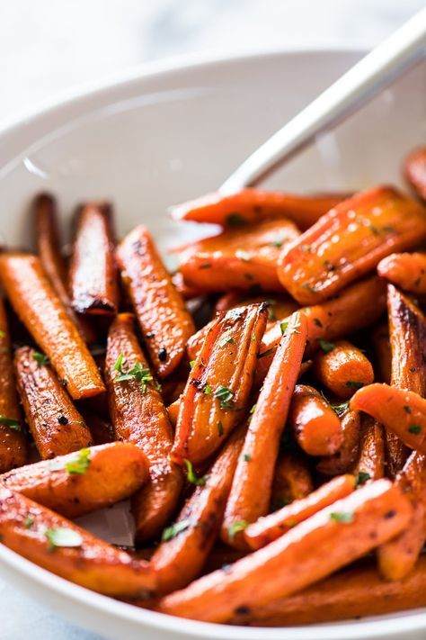 Oven roasted carrots tossed with melted butter, maple syrup, garlic and a touch of cinnamon. A great side dish worthy of being served at your holiday table! Can be made with whole or baby carrots in 30 minutes or less. Paleo, vegetarian and gluten free. #thanksgiving #easter #easysidedish #carrots Thanksgiving Carrot Recipe, Thanksgiving Carrots, Gluten Free Mexican Recipes, Carrots In Oven, Carrots Roasted, Cinnamon Carrots, Oven Roasted Carrots, Isabel Eats, Roasted Baby Carrots