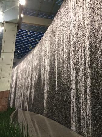 Waterfall Wall at entryway of Aria Indoor Waterfall Wall, Indoor Waterfall Fountain, Glass Waterfall, Indoor Water Features, Feature Wall Design, Outdoor Restaurant Design, Stone Wall Cladding, Pool Renovation, Indoor Waterfall