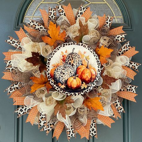 Warm Fall colors and a gorgeous Cheetah Print come together creating this inviting Country Farmhouse Pumpkin wreath. This larger sized mesh wreath would make a great addition to your indoor or outdoor decor.  A great way to complement a fall farmhouse theme. Perfect for your pumpkin or Fall decor! This mesh wreath measures approximately 27" x 27" X 8" and is created on a 14" wire frame. Talisman Beige, cream and chocolate fabric mesh provide the base for this piece. Layered on top of the base mesh are curls of a beige and cream open checked mesh which adds great texture. Coordinating ribbon streamers, decorative Fall Leaves and a festive Fall 10" round sign finish off the design, creating a warm and cozy farmhouse feel. Dimensions height: 27" x width: 27"and 8" Depth Sign: 10" diameter, me Fellowship Ideas, Dried Floral Decor, Wreath With Pumpkins, Ribbon Streamers, Wreath Inside, Farmhouse Theme, Easy Fall Decor, Gift Wreath, Fall Decor Inspiration