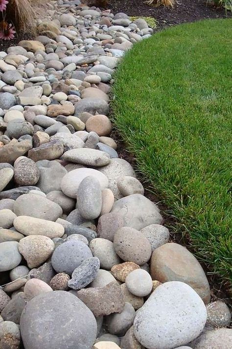 Bring the natural beauty of river-worn stones to your next landscaping project with Riverjacks aggregates. With a range of sizes and natural colors, from red to grey to tan, these stones add a unique texture to any outdoor space. Available in 50-pound bags or loose by the ton, they are a versatile and cost-effective option. #Riverjacks #Aggregates #Landscaping #OutdoorLiving #NaturalStones Diy Rock Landscaping Ideas, Diy River Rock, Rock Mulch, Rock Yard, River Rock Garden, Mulch Landscaping, River Rock Landscaping, Hardscape Design, Rock Garden Design