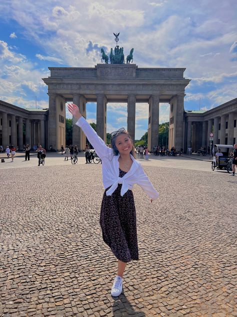 Young Asian American woman stands in front of Berlin’s Brandenburg Gate wearing a white button up shirt and a black floral dress while on a summer trip to Europe. European Summer Dress Outfit, Europe August Outfit, Austria Fashion Summer, Poland Summer Outfit, Summer Outfits In London, Modest Europe Outfits, Summer In Amsterdam Outfit, England Fashion Summer, Netherlands Outfits Summer