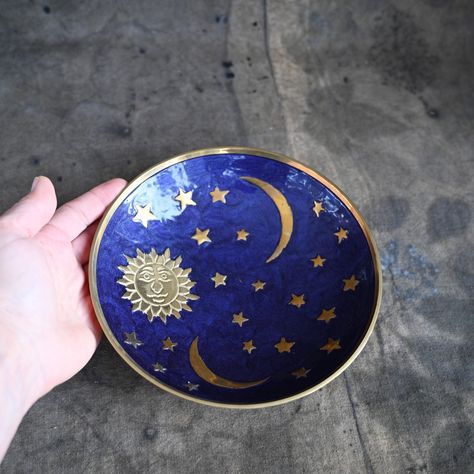 "Vintage brass trinket dish Sun moon and star plate Material: brass Enameled brass plate with Sun, moon and star design. Colors: blue and gold. Please note: color may vary slightly from image, depending on your monitor settings. Can be used as trinket dish, altar offering bowl or metal candle plate. 1) Footed enameled dish with handle (Number one in variations) diameter 5\" (12 cm) SOLD OUT 2) Small footed brass dish with ornate handle  (Number two in variations) diameter 3 1/2\" (9 cm) 3) Celes Pottery Painting Celestial, Celestial Plates, Celestial Pottery, Moon And Star Design, 3 Moon, Vintage Celestial, Diy Pottery Painting, Color Me Mine, Offering Bowls