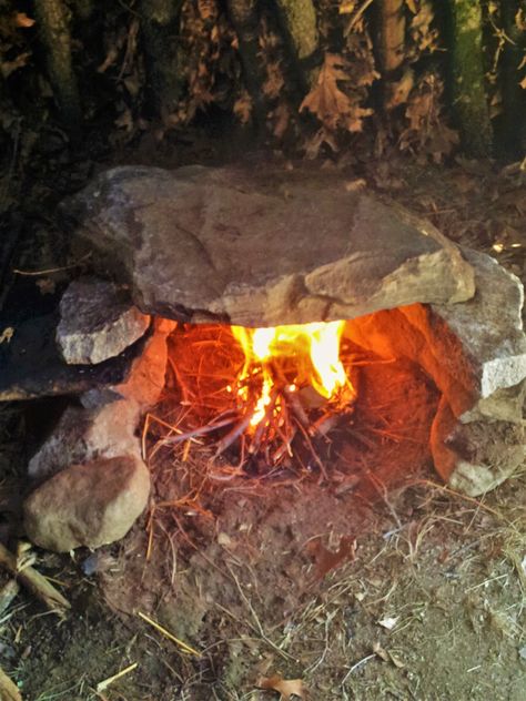 The fireplace is located right at the 2/3 - 1/3 mark. A 4" X 4' stovepipe runs from the back of the fireplace through the wall to the outside. Air circulation is good and the shelter does a great job of retaining the heat. I do plan on building a more formal fireplace using mud and stone, but that's pretty far down on my to-do list. Formal Fireplace, Miejski Survival, Bushcraft Shelter, Bushcraft Skills, Primitive Survival, Survival Quotes, Emergency Preparation, Bushcraft Camping, Survival Shelter