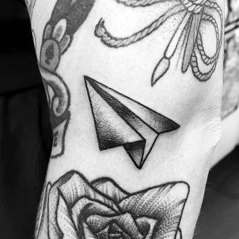 Simple Black And Gray Tattoo Design, Traditional Paper Airplane Tattoo, Small Traditional Tattoo Fillers Black, Gap Filler Tattoo Ideas Black And Grey, Skull Filler Tattoo, Black Filler Tattoo, Gap Filler Tattoo Black And Grey, Tattoo Filler Ideas Men, Paper Airplanes Tattoo