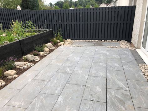 EMPEROR Classic - Nero Santiago Porcelain Paving is dark grey in colour, with light and mid-grey veins running across the surface. This design will create a timeless and elegant style in any space. Project by Scenery Garden Design. CED Stone Inspiring Beautiful Landscapes Grey Limestone Patio, Grey Slabs With White Stones Garden, Grey Paving Slabs Ideas, Dark Grey Porcelain Patio, Grey Indian Sandstone Patio, Small Back Gardens, Edging Stones, Flowers That Attract Butterflies, Space Project