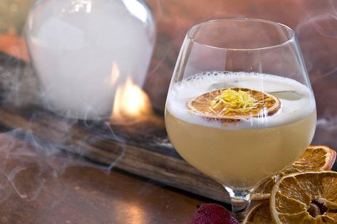 Created by James Shearer, global beverage director for Zuma Restaurants and featured in the Whisky Advocate, dated winter of 2019.  Mr. Shearer wrote, “This twist on the Penicillin is a complex combination of smoky and citrus,” Shearer says.  “The honey, yuzu, and egg whites lend sweet frothy notes, while smoke from wood fire seasons the glass, making for a layered sip.” Penicillin Cocktail, Red Sangria Recipes, Smoked Cocktails, Raspberry Cocktail, Cocktail Trends, Cocktails At Home, Winter Cocktails, Champagne Cocktail, Sangria Recipes