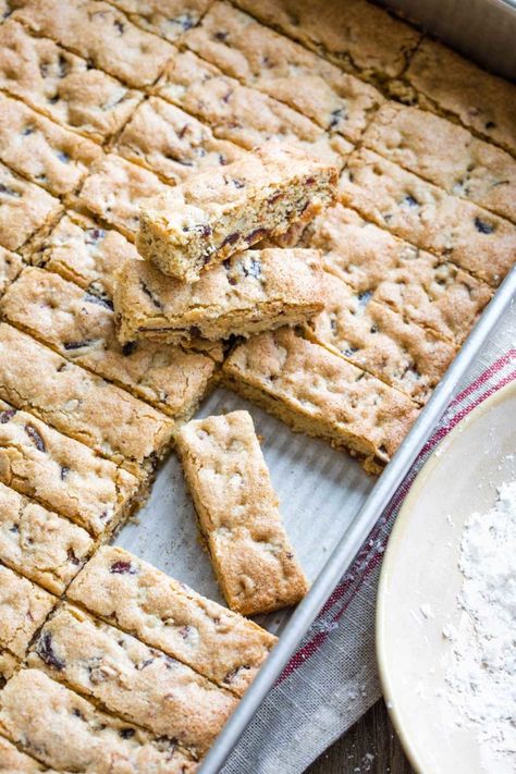 An old-fashioned treat for the holidays (or ANY day!) This delicious heirloom Date Bars recipe dates back nearly a century! Lightly crispy on the outside and perfectly chewy inside, with caramel-y dates, crunchy walnuts, and snowy powdered sugar. Plus, with whole grains and very little butter, these Date Nut Bars are actually a healthy cookie, too! Super easy and freezable – keep a few in the freezer all year long! | Christmas cookies recipes healthy | easy date bars | www.TwoHealthyKitchens.com Oat Date Bars Healthy, Date Nut Oat Bars, Date Newtons Recipe, Sweet Date Recipes, Keto Dates Recipes, Copycat Archway Date Filled Oatmeal Cookies, Oatmeal Cookies With Dates, Breakfast Cookie Bars, Date Slice Recipe