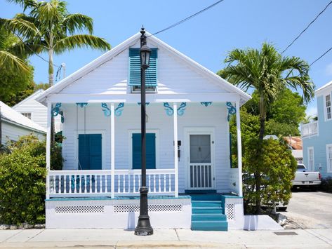 Key West-Style Homes | Interior Design Styles and Color Schemes for Home Decorating | HGTV Like blue  do-dads on porch columns. Caribbean Cottage, Cottage Tropical, Tropical Bungalow, Key West Style Homes, Florida Architecture, Key West House, White Bungalow, Key West Style, Cute Cottages