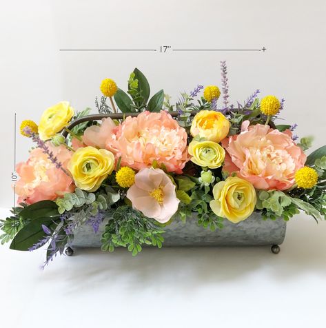 "Farmhouse Style Floral Arrangement Beautiful floral arrangement, made with high quality faux flowers and greeneries. This arrangement is made in a gorgeous color palette of peach / orange , yellow, touch of lavender and different shades of green 🌿 The arrangement has \"one face\" the back part has pretty green foliage. The container used in this arrangement is gray metal galvanized. Made with lots of love and attention to detail, this beautiful arrangement had been crafted in my home studio in Farmhouse Flowers, Farmhouse Nursery Decor, Wedding Orange, Large Floral Arrangements, Summer Centerpieces, Spring Arrangements, Silk Arrangements, Spring Floral Arrangements, Bridal Shower Flowers