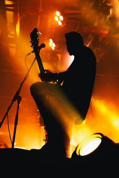 Photo silhouette of a musician | Premium Photo #Freepik #photo #rock-concert #live-concert #stage-performance #live-band Musician Silhouette, Concert Stage, Live Band, Rock Concert, Stage Performance, Psd Icon, Live Concert, Vector Photo, Premium Photo