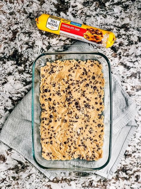 Step one: Flatten chocolate chip cookie dough into bottom of a baking pan. Cookie Bottom Dessert, Cookie Bars With Premade Dough, Tollhouse Cookie Dough Recipes, Recipes With Premade Cookie Dough, Chocolate Chip Cookie Crust Dessert, Recipes Using Cookie Dough, Chocolate Chip Cookie Dough Desserts, Refrigerated Cookie Dough Recipes, Pillsbury Cookie Dough Recipes