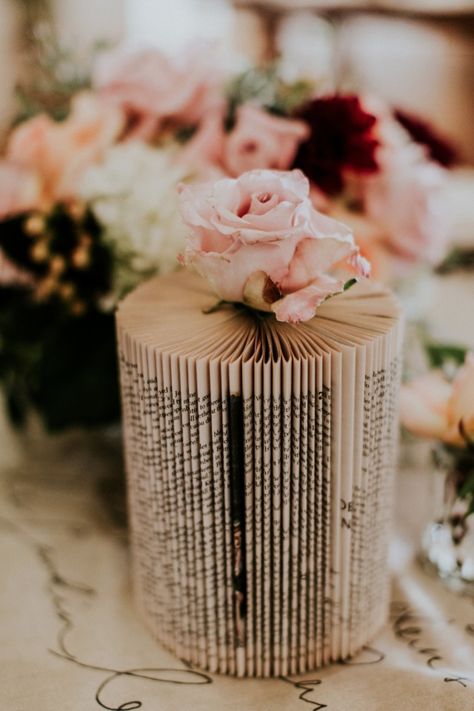 Cool book vase idea Book Inspired Centerpieces, Book Stack Centerpieces Wedding, Guest Book Table Flower Arrangement, Book Lovers Wedding Wedding Table Decor, Book Page Centerpieces, Book Page Party Decorations, Book Vases, Book Centerpiece, Book Themed Tablescape