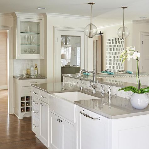 Beautiful kitchen features a white kitchen island topped with gray quartz fitted with a farmhouse sink and a vintage style faucet illuminated by Arteriors Caviar Pendants. Kitchen Countertops Grey, Gray Countertops, Grey Quartz Countertop, Gray Quartz Countertops, Kitchen Island Tops, Best Kitchen Countertops, Gray Quartz, Outdoor Kitchen Countertops, Kitchen Countertop Materials