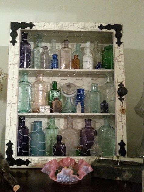 Crackle paint, chicken wire cabinet for antique bottle display Old Bottle Display Ideas, How To Display Old Bottles, Vintage Bottles Display, Display Bottle Collection, Decorating With Old Glass Bottles, Old Glass Bottles Ideas Display, Displaying Old Bottles, Vintage Bottle Display, Antique Bottle Display Ideas