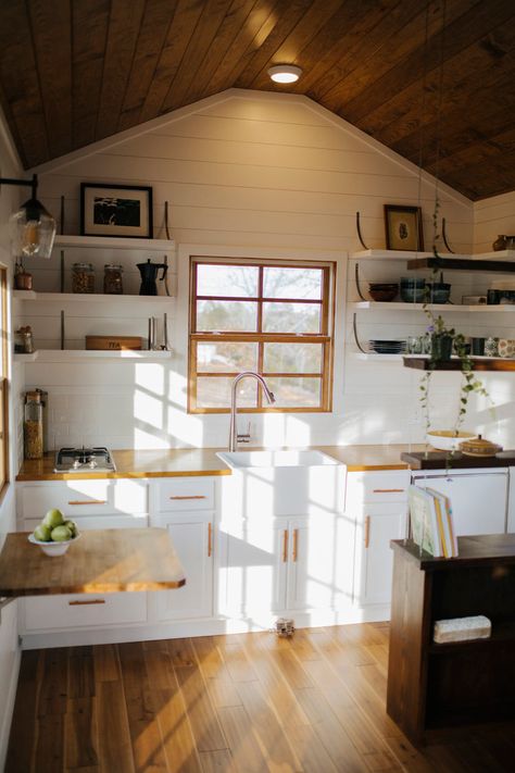 The kitchen has open shelving, custom steel brackets, a farmhouse sink, and butcher block countertops. Tiny Farmhouse, Tiny House Builders, Small Tiny House, Wind River, Best Tiny House, Farmhouse Kitchen Cabinets, Tiny House Kitchen, Minimalist Life, Tiny House Movement