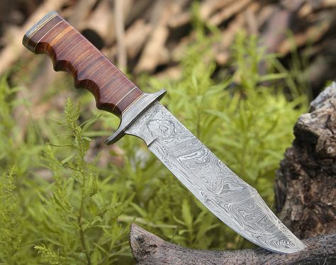 Material: Hand forged 350 layers twisted Damascus steel blade, Damascus guard and pommel, 100 layers stacked leather handle. •Overall length is 11.0” •Blade length is 6.0” •Blade thickness is 4.0 mm or 2/8th of an inch. Package Includes: 1x Handmade Damascus steel hunting bowie knife. 1x Hand stitched leather sheath. 1x Box Care instructions Personalization Damascus Blade, Belt Holster, Camping Tools, Leather Roll, Damascus Knife, Bowie Knife, Camp Knife, Outdoor Gift, Hunting Gear