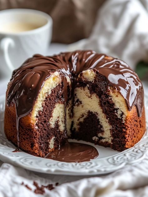 Just Baked This Classic Marble Cake from Scratch! 🍰✨    🍴 𝗜𝗻𝗴𝗿𝗲𝗱𝗶𝗲𝗻𝘁𝘀 🎉  For the Cake: 2 1/2 cups all-purpose flour 2 1/2 teaspoons baking powder 1/2 teaspoon salt 🧂 1/2 cup unsalted butter, softened 🧈 1/2 cup vegetable oil 🌻 2 cups granulated sugar 🍚 4 large eggs 🥚 1 teaspoon vanilla extract 🍨 1 cup whole milk 🥛 1/4 cup unsweetened cocoa powder 🍫 1/4 cup hot water 💧 For the Frosting (Optional):  1 cup unsalted butter, softened 🧈 4 cups powdered sugar 1/4 cup whole milk Marble Bundt Cake, Marbled Cake, German Chocolate Cheesecake, Cake From Scratch, Unsweetened Cocoa Powder, Dessert Bites, Cupcake Recipes Chocolate, Marble Cake, Just Bake