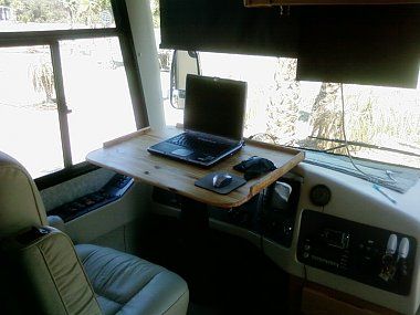 Custom steering wheel computer table.  Especially in a Class C, turning the cab into usable space would be a good idea.  We hang thermal curtains from the cabover bed to isolate the cab, so this would give a little privacy to one of the boys if they wanted to watch a movie or something. Imax Theater, Desk Station, Camper Mods, Bus Remodel, Monaco Style, Small Motorhomes, Lightweight Trailers, Homemade Camper, Fifth Wheel Trailers