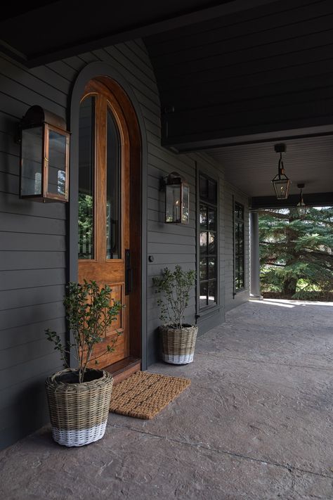 Explore moody lanterns for outdoor charm. Compare electric vs. gas, get lighting tips, and find your perfect fixture! Benjamin Moore Brown, Brown Front Door, Modern Cottage Bathroom, Front Porch Lighting, Mountain Spring, Chris Loves Julia, Exterior Renovation, Farmhouse Inspiration, Outdoor Hanging Lanterns