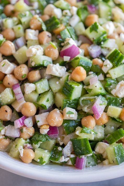 This Herby Cucumber Salad with Feta and Chickpeas is flavorful, refreshing and easy to make!  It's a great side dish for a potluck or BBQ, but is also delicious stuffed into a warm pita for lunch.  You only need a few simple ingredients to make this tasty summer salad! #summersalad #cucumbersalad #BBQSide #easyrecipe #vegetarian #chickpeasalad Cucumber Salad With Chickpeas, Chickpea And Cucumber Salad, Chickpea Cucumber Feta Salad, Recipes With Cucumber, Chickpea Cucumber Salad, Chickpea Feta Salad, Dip For Chips, Cucumber Feta Salad, Salad Dip