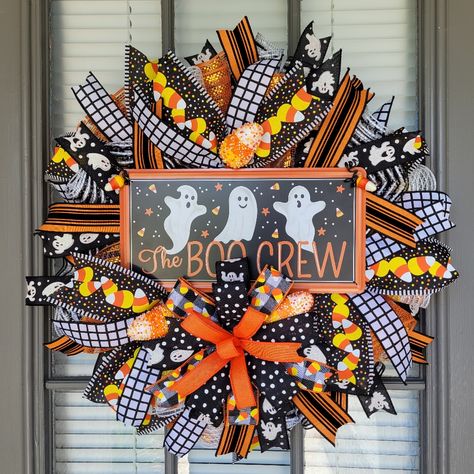 Get Into The Halloween Spirit With This Spooky Ghost Wreath! This Wreath Is Made With Premium Deco Mesh, Foam Candy Corn And Coordinating Wired Ribbon. Also Attached Is An Adorable Metal Ghost Sign That Reads " The Boo Crew" This Handmade Wreath Is Perfect For Halloween. This Wreath Is Sure To Add An Adorable Eerie Touch To Your Front Door Or In Your Home Measuring 21" X 21" X 7" This Wreath Should Be Displayed In An Area Sheltered From Direct Weather Elements As It May Cause Fading Over Time. A Foam Candy, Fall Ribbon Wreath, Ghost Wreath, Spooky Candy, Halloween Door Wreaths, Halloween Mesh Wreaths, Boho Wreath, Diy Halloween Wreath, Candy Cane Wreath