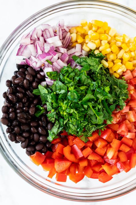 Mexican black bean and corn salad - a healthy plant based side salad with red pepper, tomato and avocado and a light cilantro lime dressing. Corn Salad With Cilantro, Red Bean Salad, Bean Bowls, Salad With Cilantro Lime Dressing, Healthy Light Lunches, Black Bean And Corn Salad, Bean And Corn Salad, Mexican Black Beans, Mexican Salad Recipes