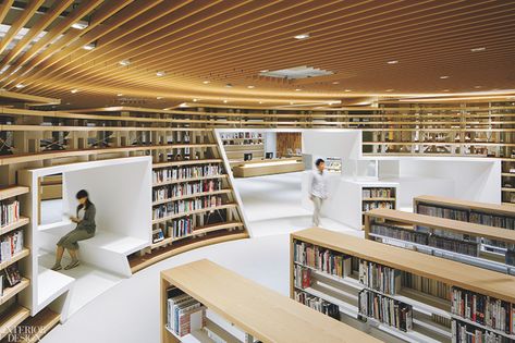 Books tend to be rectilinear. But that doesn’t mean their repositories have to be. For this library in Kumamoto, Japan, design director Kazunobu Nakamura conceived a system of curved shelves to evoke the Kikuchi River, which runs through the city, located on the island of Kyushu. The nearly 330 linear feet of bookcases—composed of steel columns supporting shelves of pale Japanese ash finished with clear urethane—wind through the 18,300-square-foot space, dividing it into discrete nooks. Public Library Design, Interior Design Competition, Library Architecture, Central Library, Steel Columns, Green Architecture, Cultural Architecture, Library Design, Design Competitions